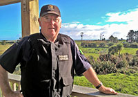 HFO Barry Nicolle standing outside with farm land in the background