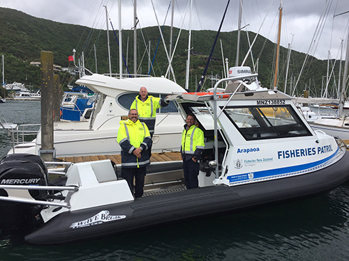 (l-r) MPI fishery officer Chris Beal and honorary fishery officer James Dixon on board the Arapaoa with fishery officer Ramon Smith (on wharf)