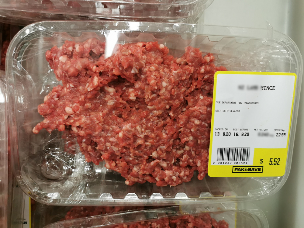 A pack of Pak'n Save brand mince in a meat tray covered with clear plastic with a label attached showing the weight, price, and other information.