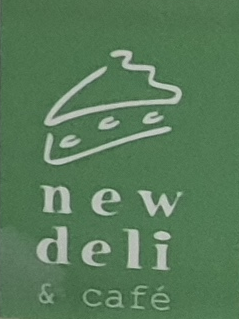 has the words new deli & cafe on a green background