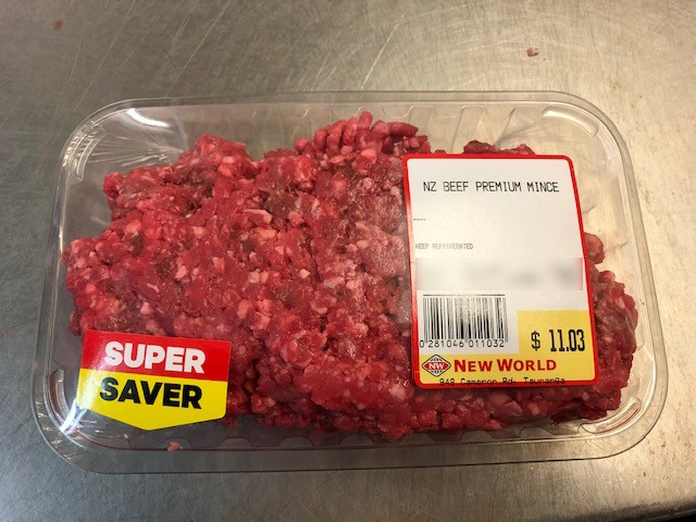 Photo of New World Gate Pa brand NZ Beef Premium Mince. The product is in a clear plastic-wrapped tray with labels on the top.
