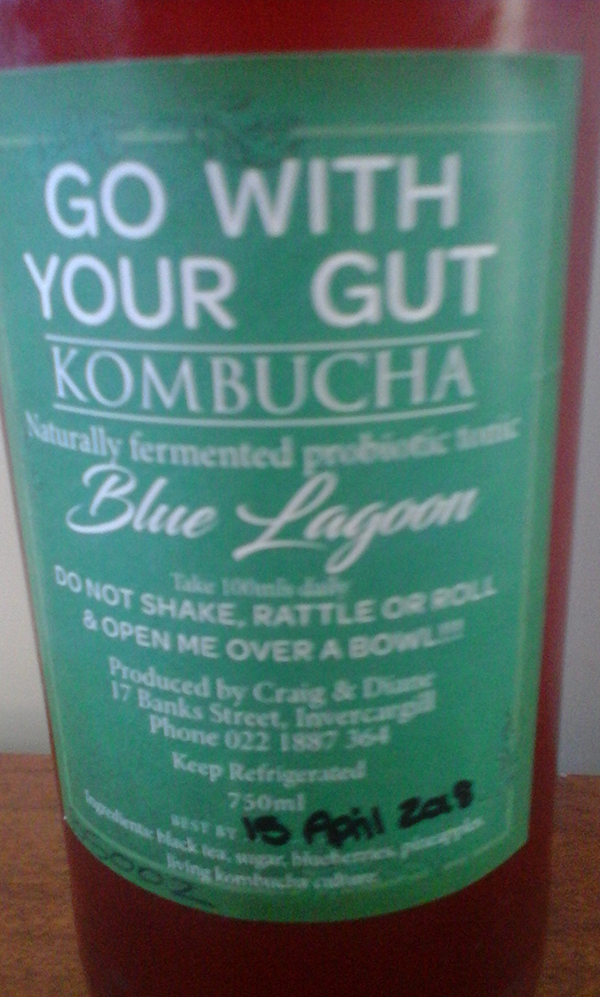 A closeup of a blue lagoon label on a bottle of kombucha.