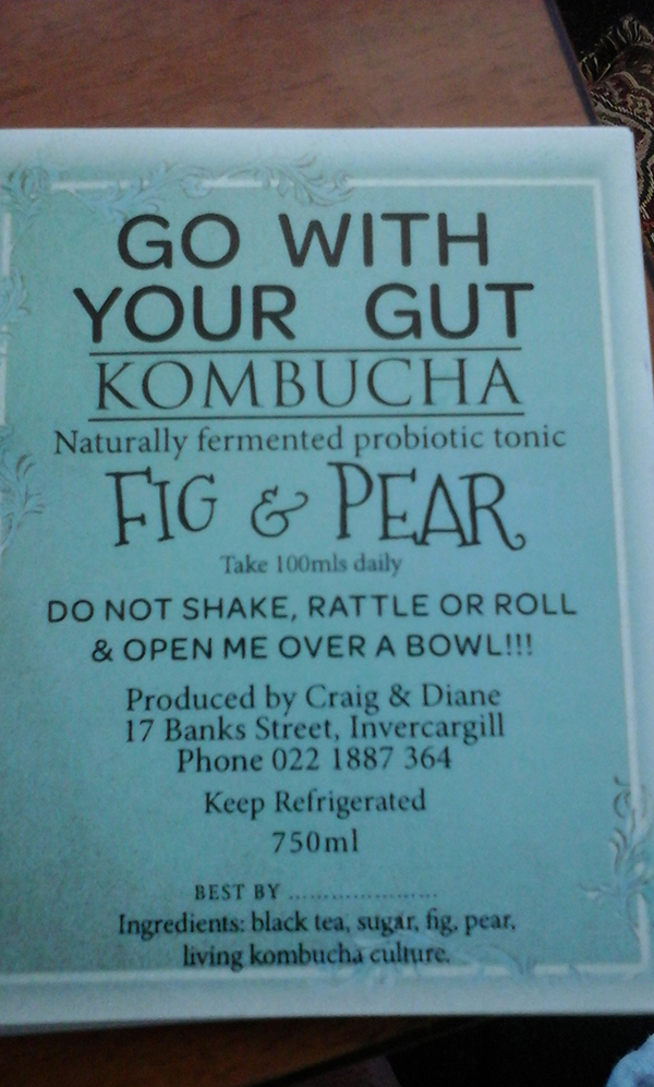 A closeup of a fig and pear label on a bottle of kombucha