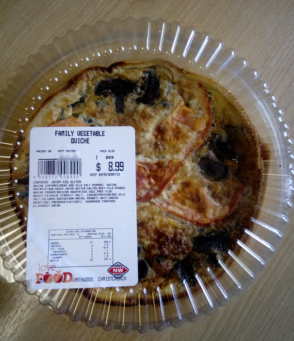 Photo of(1 whole Quiche) in a plastic container